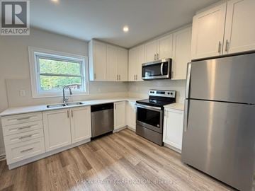 Mississauga (Lakeview) apartment for rent - A kitchen with white cabinets and stainless steel appliances.