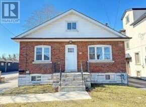Mississauga (Lakeview) apartment for rent - A small brick house with a white door and windows is for sale.