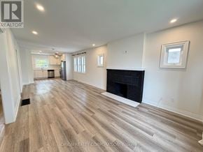 Mississauga (Lakeview) apartment for rent - A spacious living room with a fireplace and wood flooring.