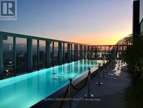 Toronto (Waterfront Communities) condo for rent - A long rectangular pool with a glass wall on one side.