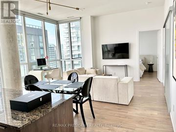 Toronto (Waterfront Communities) condo for rent - A modern living room with a dining table and chairs.