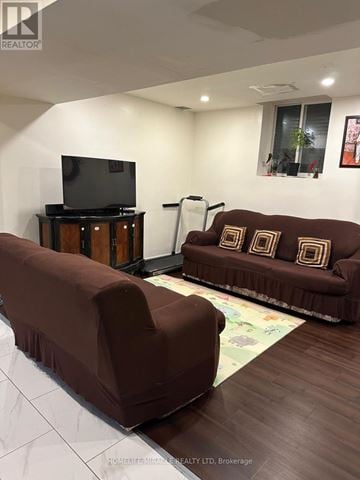 Brampton (Credit Valley) apartment for rent - A living room with a brown couch and a television.