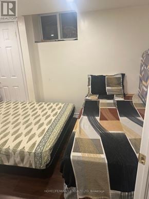 Brampton (Credit Valley) apartment for rent - A bedroom with a bed and a row of rugs on the floor.