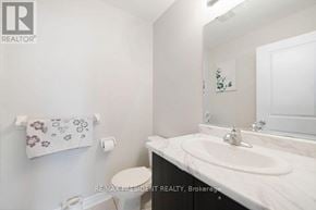 Brampton (Northwest Brampton) townhouse for rent - A white bathroom with a toilet, sink, and toilet paper roll.