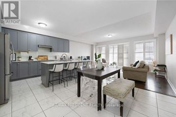 Brampton (Northwest Brampton) townhouse for rent - A modern kitchen with a dining table set for four.