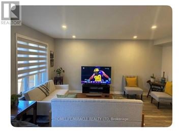 Niagara Falls (Oldfield) townhouse for rent - A living room with a television displaying a cartoon character.