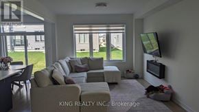 Shelburne townhouse for rent - A living room with a couch, chair, and television.