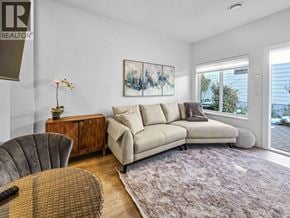 Burnaby apartment for rent - A living room with a couch, chair, and rug.