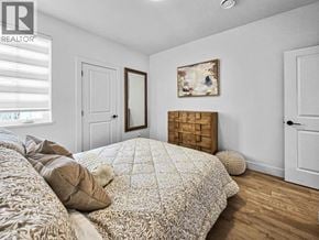 Burnaby apartment for rent - A bedroom with a large bed and a painting on the wall.