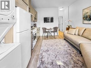 Burnaby apartment for rent - A modern kitchen with a dining table and chairs in the middle of the room.
