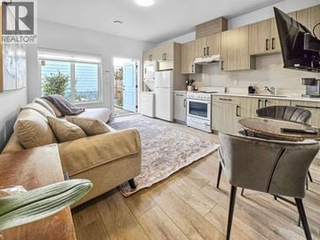 Burnaby apartment for rent - A living room with a couch and a dining table.