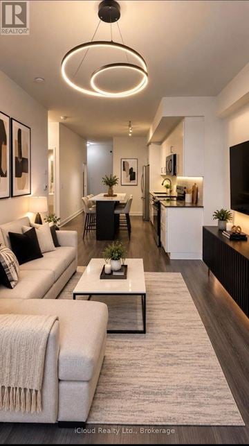 Barrie (Painswick South) condo for rent - A modern living room with a white sofa and a coffee table.