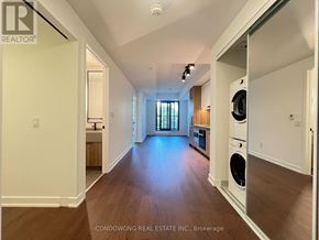 Toronto (Forest Hill South) condo for rent - A spacious, well-lit room with wood flooring and a washer and dryer in the corner.