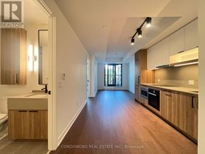 Toronto (Forest Hill South) condo for rent - A modern kitchen with wooden cabinets and a large island.