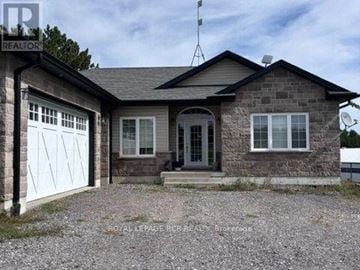 Caledon apartment for rent - A house with a garage and a gravel driveway is for sale.
