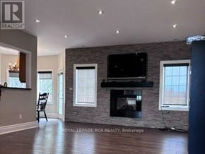 Caledon apartment for rent - A living room with a fireplace and a flat screen TV.