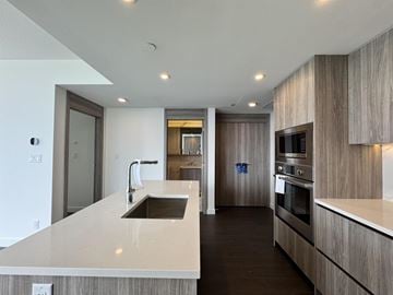 Surrey apartment for rent - A modern kitchen with a sink and stove.