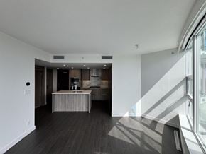Surrey apartment for rent - A modern kitchen with a wooden island and a view of the city.