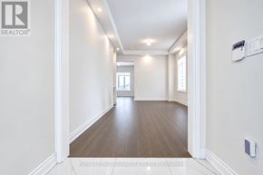 Aurora (Aurora Estates) apartment for rent - A long, empty hallway with white walls and wood flooring.