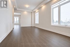 Aurora (Aurora Estates) apartment for rent - A spacious room with wooden flooring and white walls, with a window showing a snowy landscape outside.