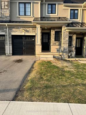 Hamilton (Ryckmans) townhouse for rent - A house with a black garage door is numbered 140.