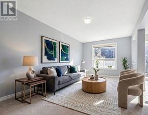 Guelph (Grange Road) apartment for rent - A living room with a grey couch, a wooden coffee table, and a rug.