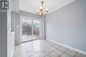 Guelph (Grange Road) apartment for rent - A room with a chandelier and sliding glass doors leading to a backyard.