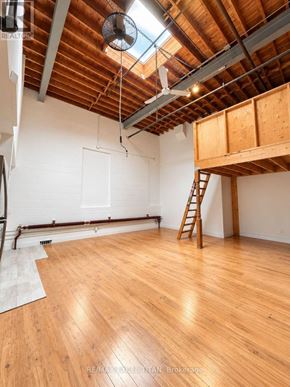 Toronto (Dufferin Grove) condo for rent - A room with wooden floors and a skylight.