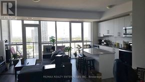 Kitchener condo for rent - A modern kitchen with a bar stool and a view of the city.