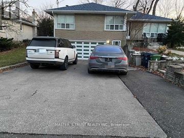 Toronto (Newtonbrook East) apartment for rent - Two cars are parked in a driveway in front of a house.