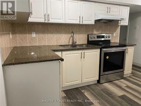 Toronto (Newtonbrook East) apartment for rent - A kitchen with a black stove top oven and white cabinets.