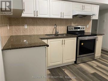 Toronto (Newtonbrook East) apartment for rent - A kitchen with a black stove top oven and white cabinets.