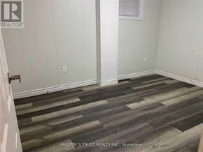 Toronto (Newtonbrook East) apartment for rent - A room with wooden flooring and a white wall.