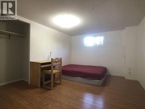 Vancouver apartment for rent - A bedroom with a bed, desk, and chair.
