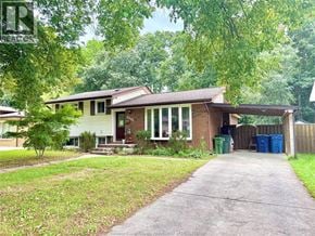 Windsor apartment for rent - A house with a driveway and a green trash can.