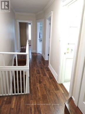 Toronto (South Riverdale) apartment for rent - A white railing in a room with wooden floors.