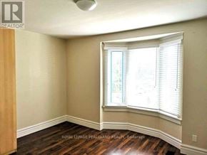 Toronto (South Riverdale) apartment for rent - A room with a window and wooden flooring.