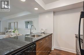 Toronto (Agincourt South-Malvern West) condo for rent - A modern kitchen with a black countertop and stainless steel appliances.