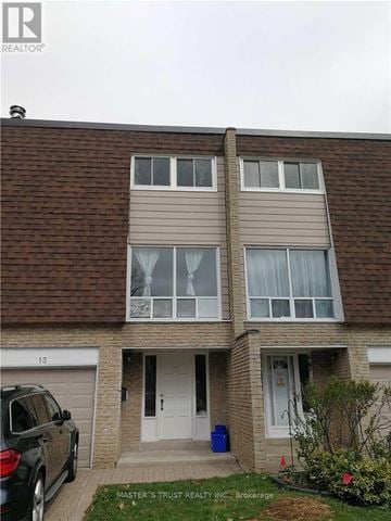 Markham (Unionville) townhouse for rent - A brown brick house with a white door and windows.