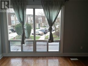 Markham (Unionville) townhouse for rent - A view of a street through a sliding glass door.