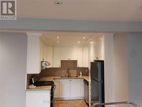 Markham (Unionville) townhouse for rent - A kitchen with a refrigerator, sink, and cabinets.