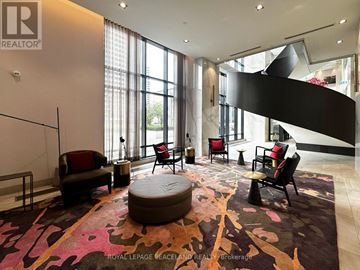 Toronto (Islington-City Centre West) condo for rent - A living room with a large rug and a spiral staircase.