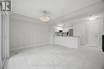 Mississauga (Churchill Meadows) townhouse for rent - A spacious kitchen area with white cabinets and a marble countertop.