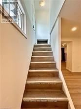 Niagara Falls (Hospital) apartment for rent - A set of stairs with a wooden handrail.