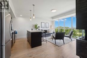 Niagara Falls (Oldfield) condo for rent - A modern kitchen with a refrigerator, sink, and dining table.