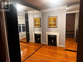 Toronto (The Beaches) apartment for rent - A room with a fireplace and a painting on the wall.