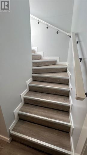 Sudbury apartment for rent - A staircase with a white railing and wooden steps.