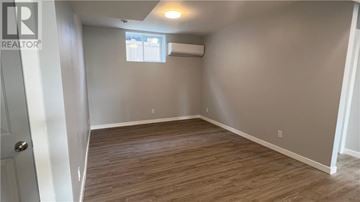 Sudbury apartment for rent - A modern kitchen with a stainless steel refrigerator and wooden flooring.