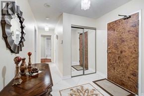 Toronto (Willowdale West) condo for rent - A hallway with a wooden table and a mirror on the wall.