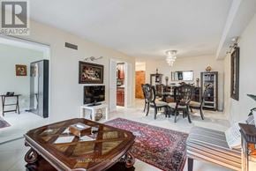 Toronto (Willowdale West) condo for rent - A living room with a wooden coffee table and a television.